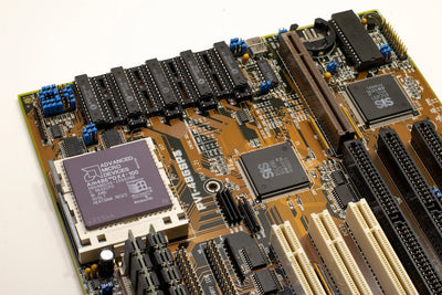 A detailed close-up of a vintage motherboard highlighting microprocessor and electronics components.