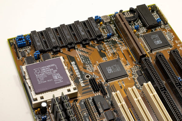 A detailed close-up of a vintage motherboard highlighting microprocessor and electronics components.