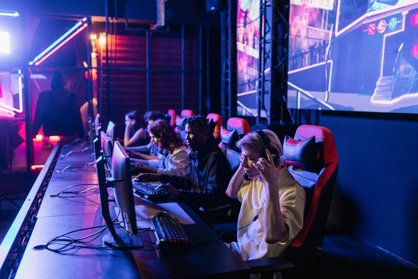Focused gamers in a high-tech arena compete intensely, showcasing esports fervor.