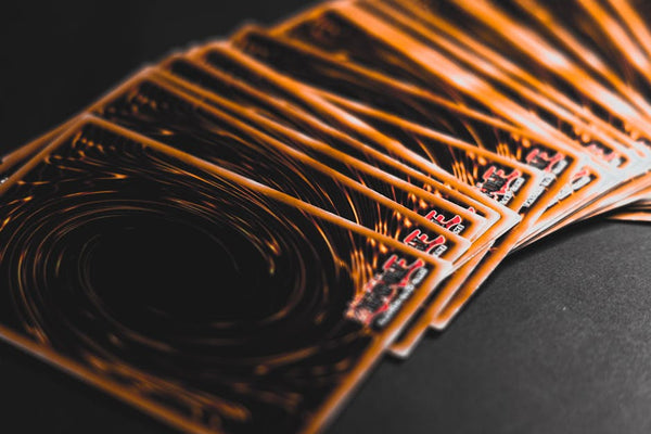 Close-up view of collectible trading cards in a fan arrangement, highlighting intricate patterns.