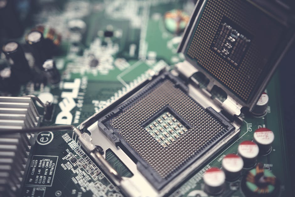Detailed close-up shot of a computer motherboard featuring an open CPU socket and electronic components.