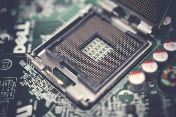 Detailed view of a CPU socket on a circuit board, highlighting electronic components.