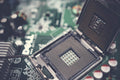 Detailed view of a CPU socket on a green motherboard, showcasing microprocessor technology.