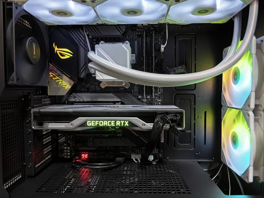 Detailed view of a gaming PC build featuring a GeForce RTX graphics card and RGB lighting in a sleek black case.