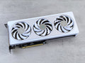 Stylish white graphics card with three cooling fans on a neutral background, ideal for tech enthusiasts.
