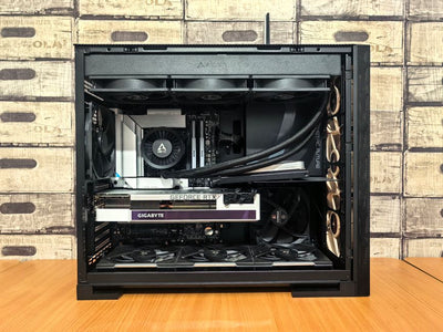 Detailed view of a custom-built gaming PC with visible components like graphics card and cooling system.