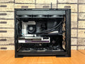 Detailed view of a custom-built gaming PC with visible components like graphics card and cooling system.