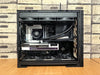 Detailed view of a custom-built gaming PC with visible components like graphics card and cooling system.