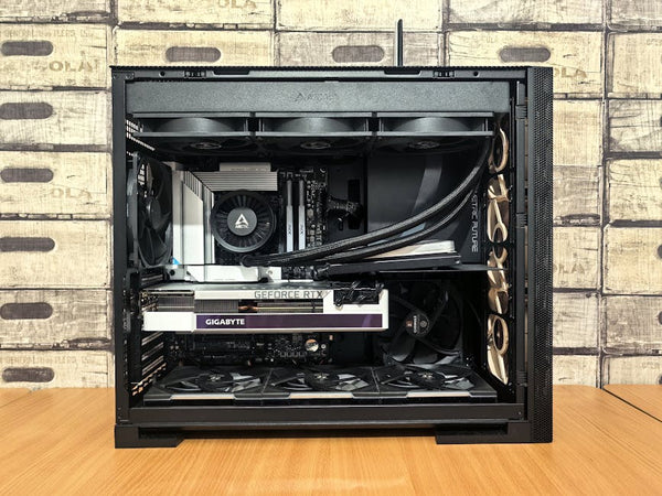 Detailed view of a custom-built gaming PC with visible components like graphics card and cooling system.