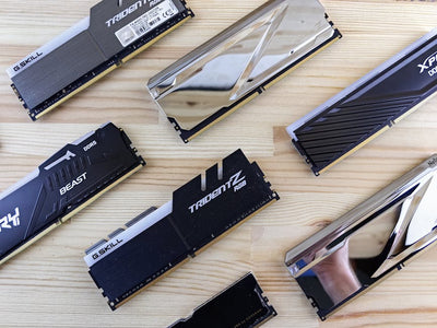 Top view of modern computer RAM sticks arranged on a wooden surface for technology enthusiasts.