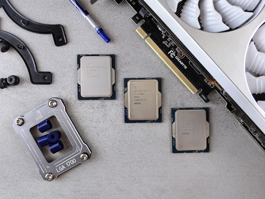 Overhead view of CPUs, graphics card, and mounting equipment on gray background, emphasizing modern technology.