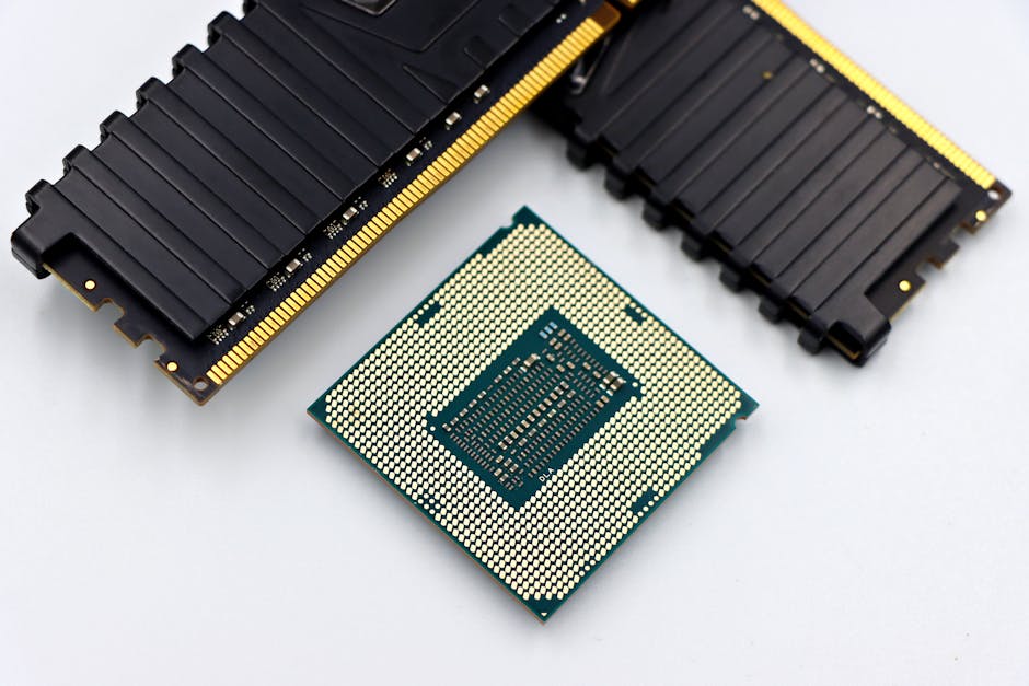A CPU and RAM sticks displayed on a white surface, showcasing computer hardware components.