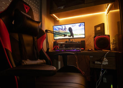 A dimly lit room showcasing an advanced gaming desktop setup with modern equipment.