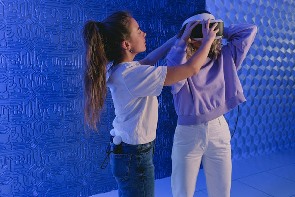 Two women exploring virtual reality technology in a modern indoor setting.