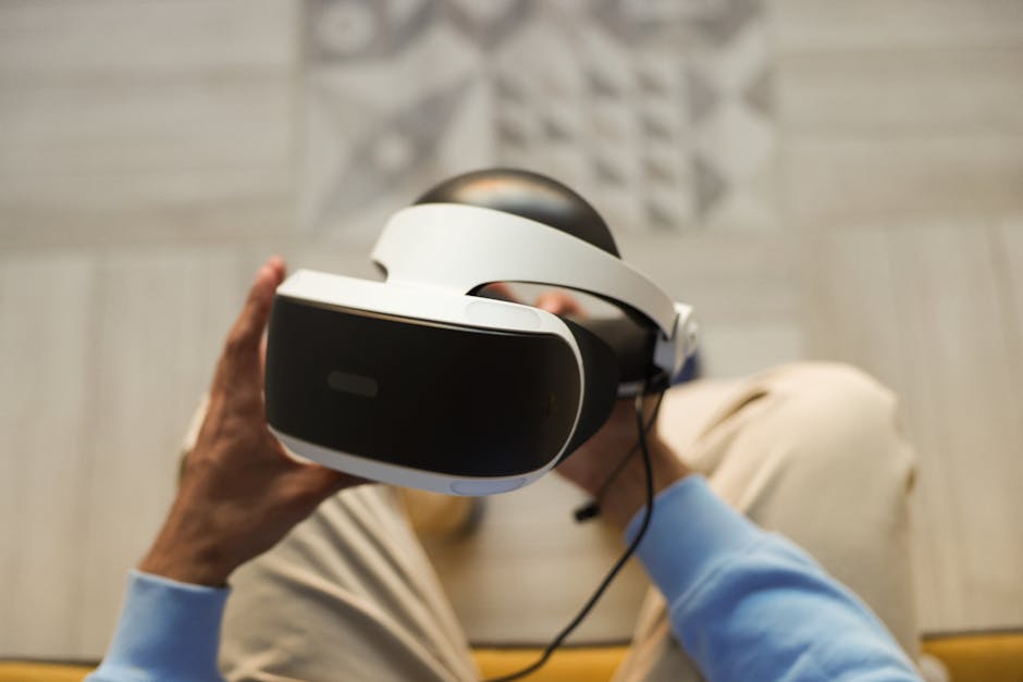 Hands holding VR headset for immersive virtual reality experience.