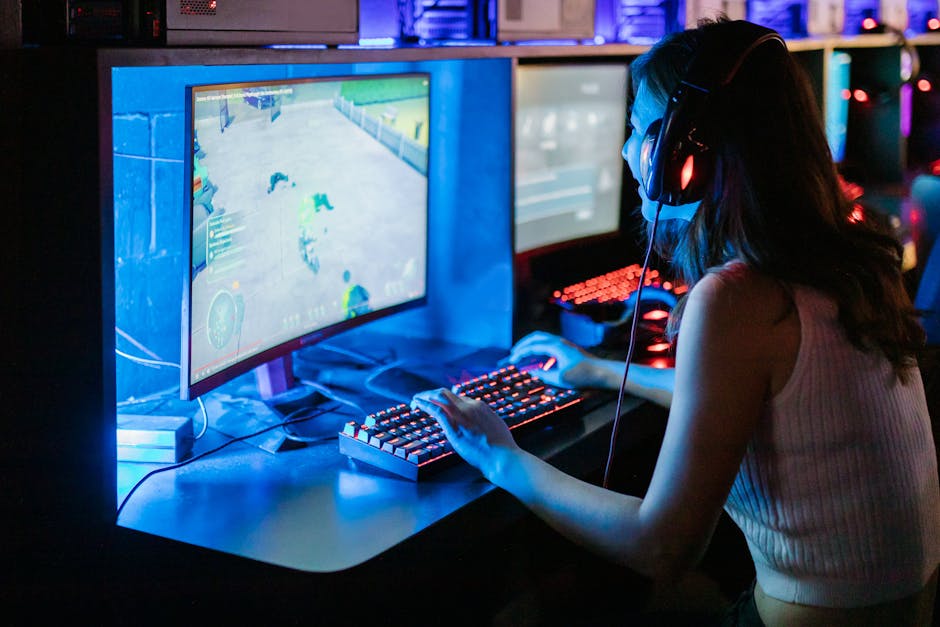 Woman enjoying a vibrant gaming session at a computer setup with a mechanical keyboard.