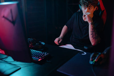 Young man intensely focused on a gaming session at night, highlighting the competitive esports atmosphere.